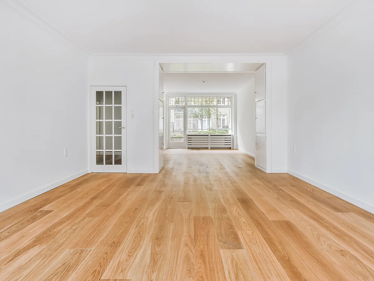 Freshly finished oak hardwood floor running the length of a bright Sioux Falls, SD room