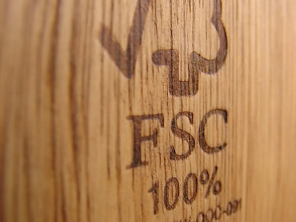 Forest Stewardship Council certification mark branded into a hardwood board