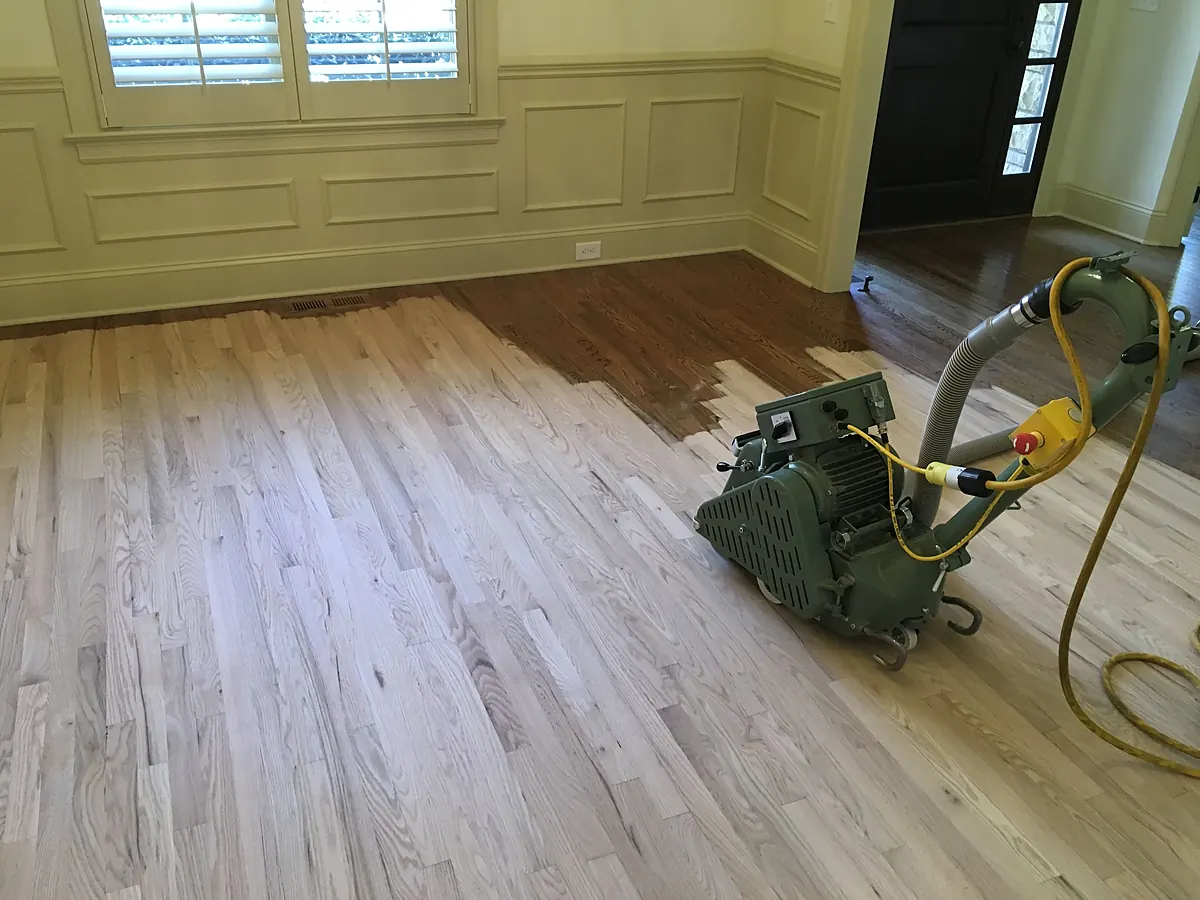 Drum sander taking a hardwood floor back to bare wood during a dustless refinish in Sioux Falls, SD