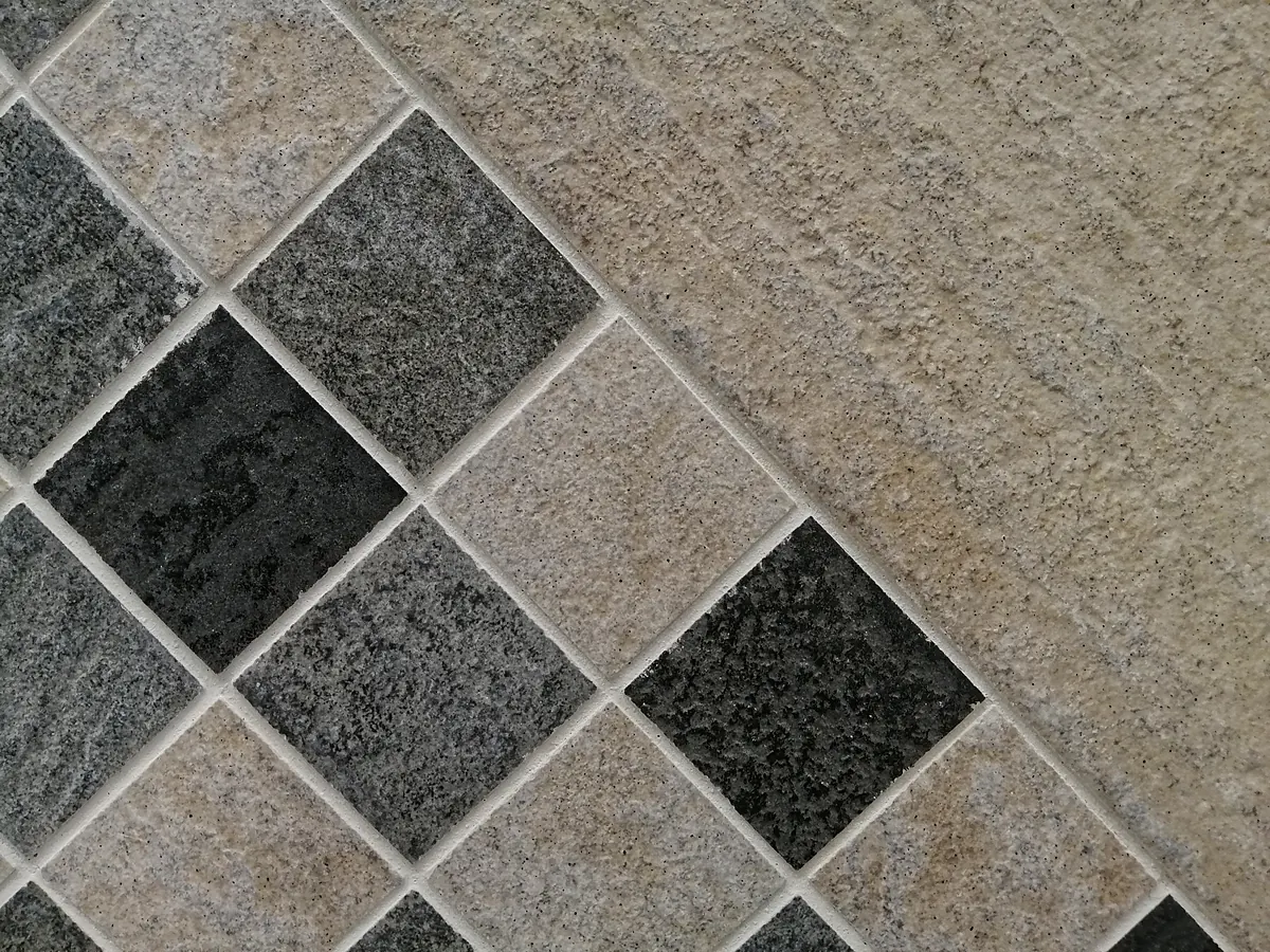 Porcelain and natural stone floor tile set in a diamond pattern with grout lines in a Sioux Falls, SD home